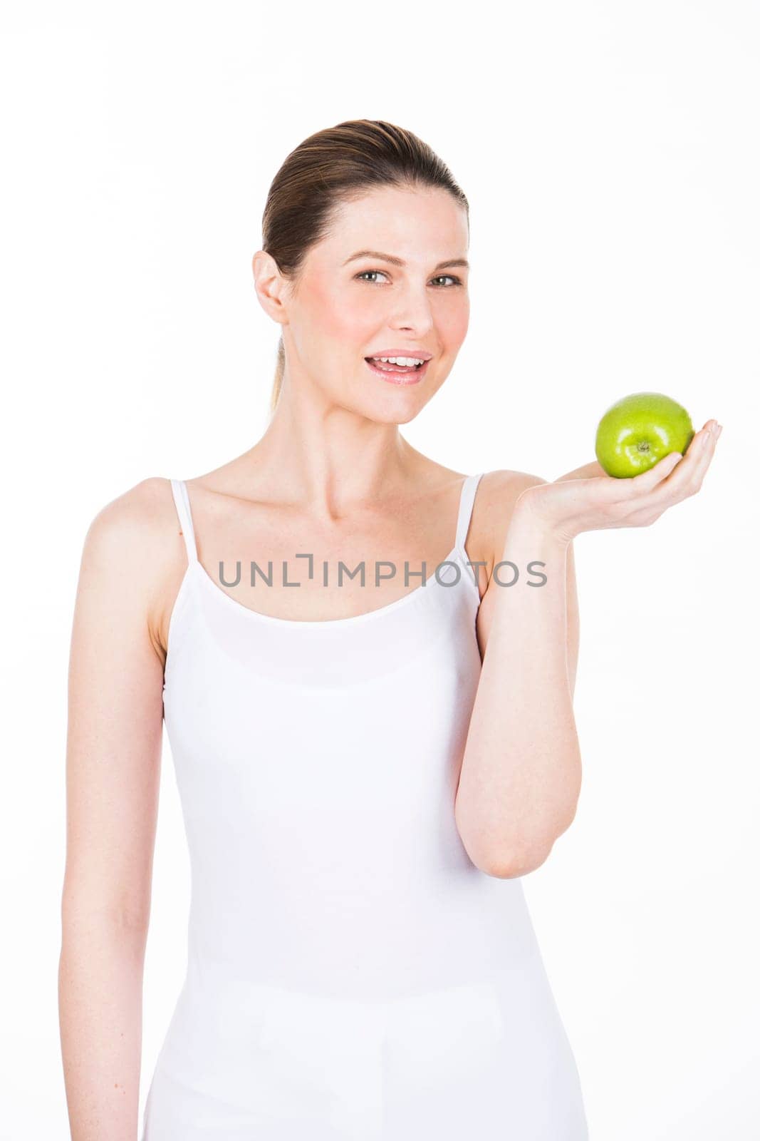 young woman holding an apple and looking at camera.
