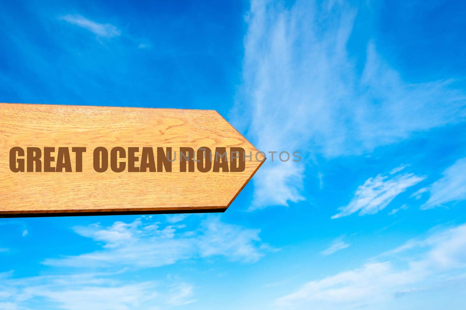 Wooden arrow sign pointing destination GREAT OCEAN ROAD, AUSTRALIA  against clear blue sky with copy space available. Travel destination concept  image