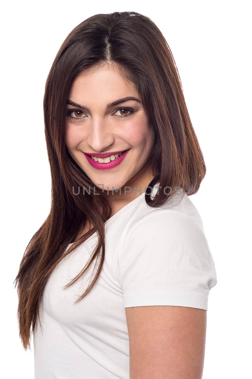 Sideways of young woman looking at camera