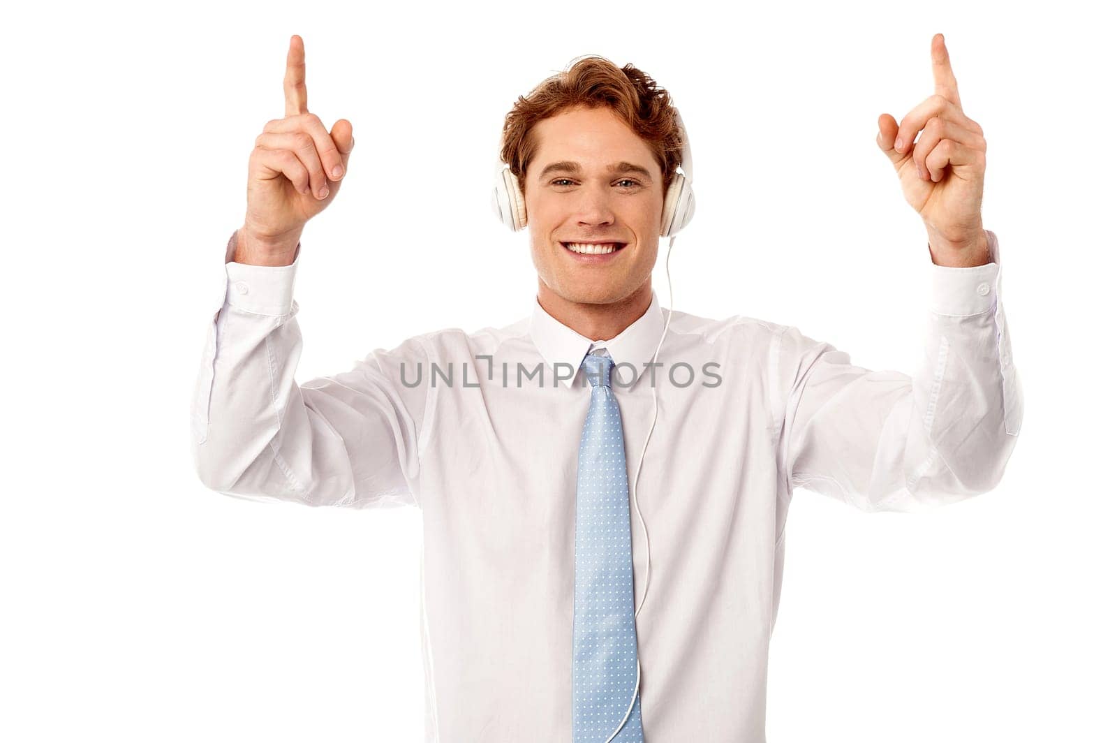 Young male executive listening music and dancing