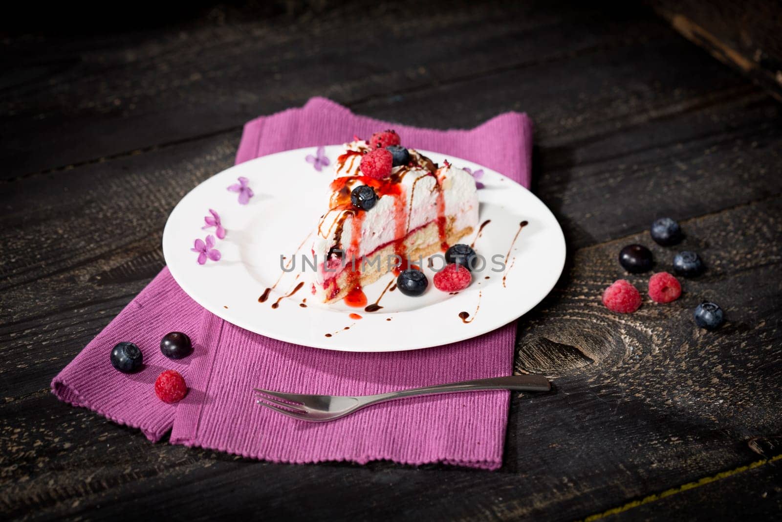 Raspberry cream cake with fresh raspberries and blueberries