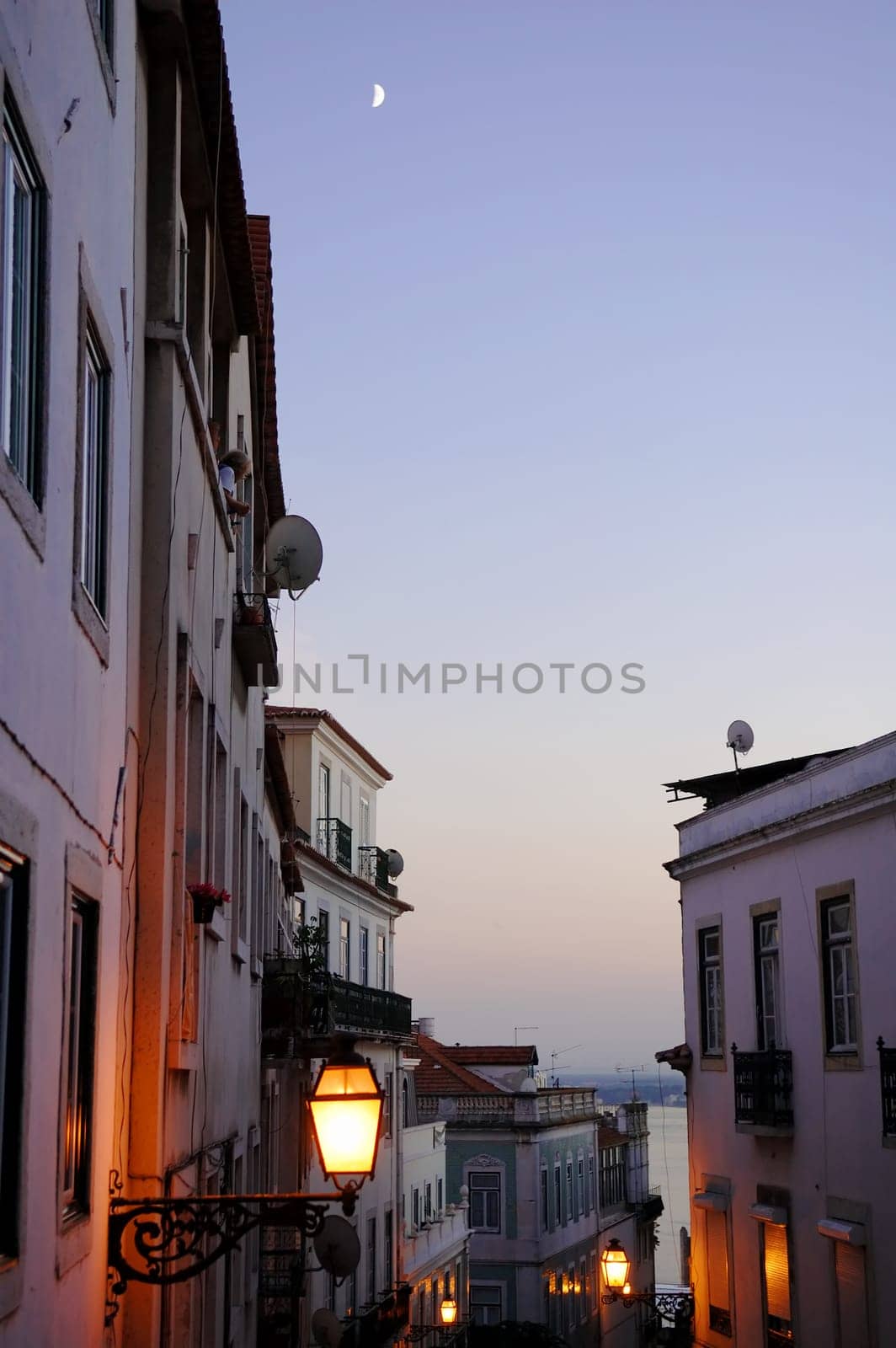 The antique lantern (street lamp) hanging on the (exterior) wall of residential house