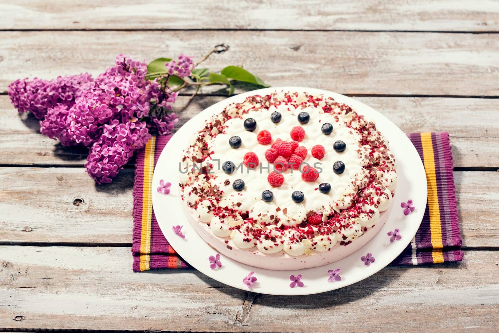 Raspberry cream cake with fresh raspberries and blueberries
