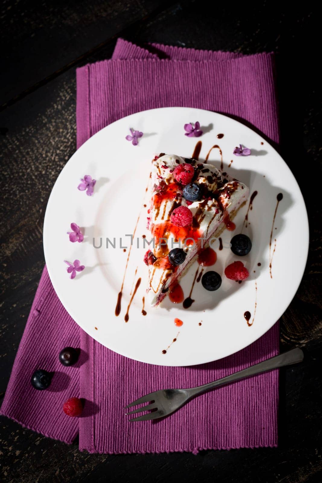Raspberry cream cake with fresh raspberries and blueberries