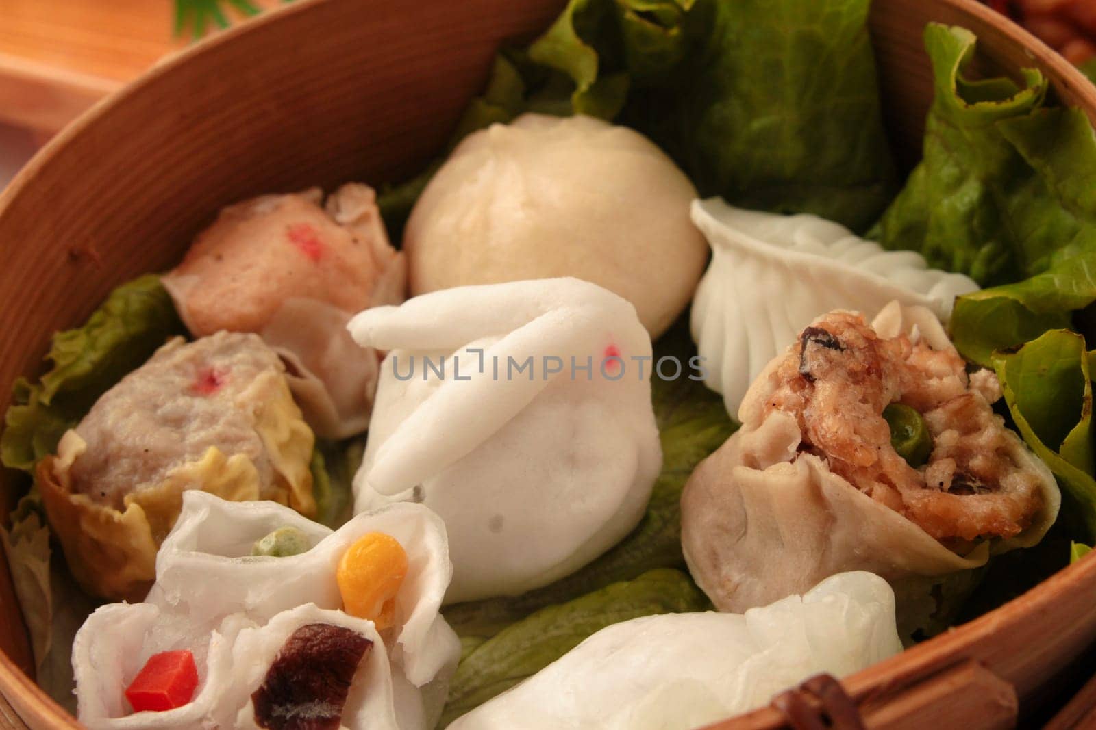 wontons in wooden bowl with sticks