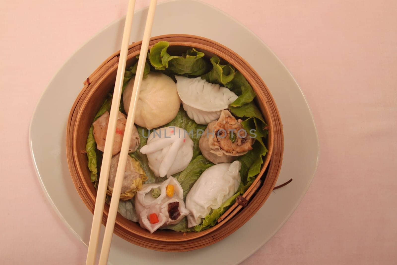 wontons in wooden bowl with sticks