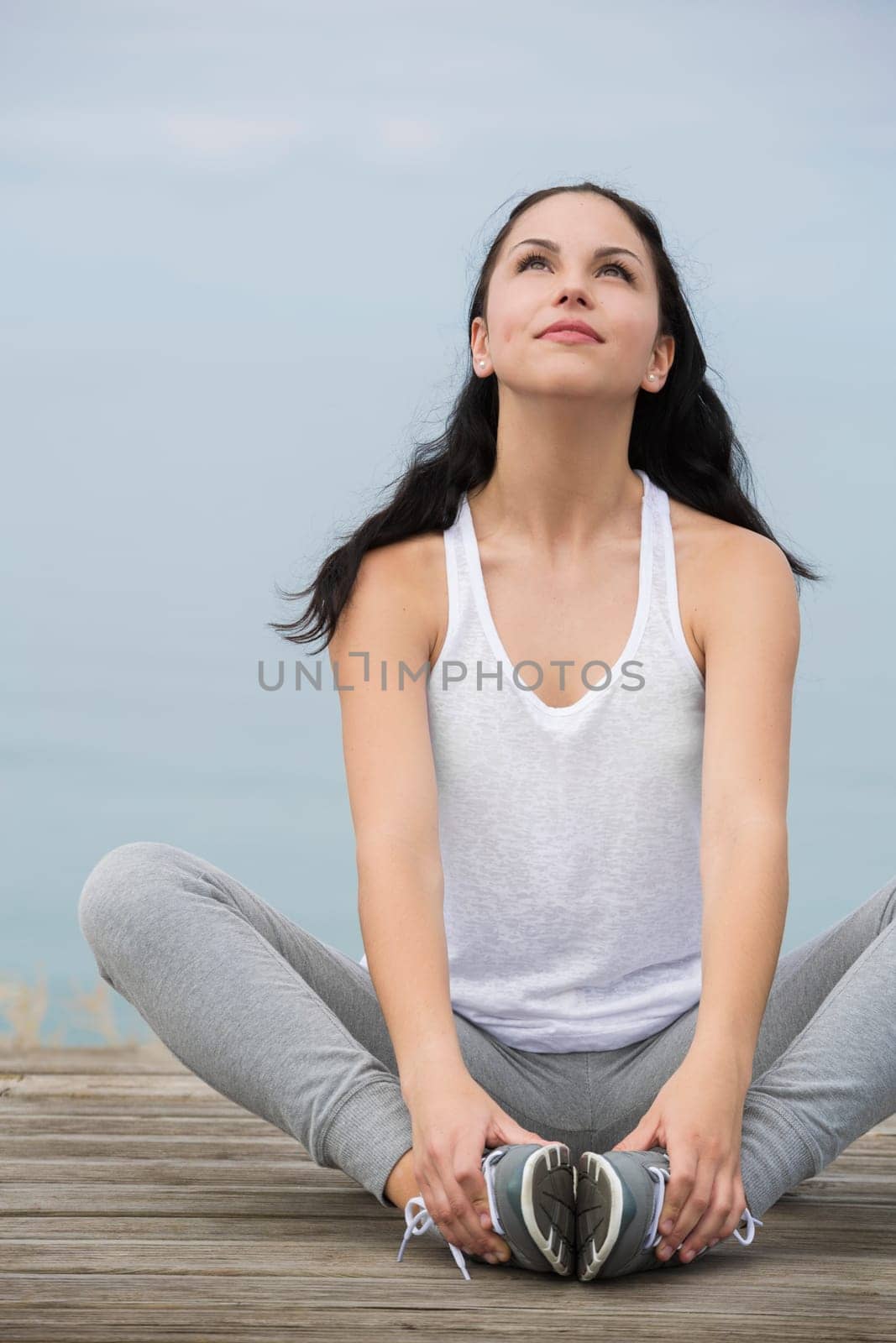 Beautiful young woman in outdoor doing yoga