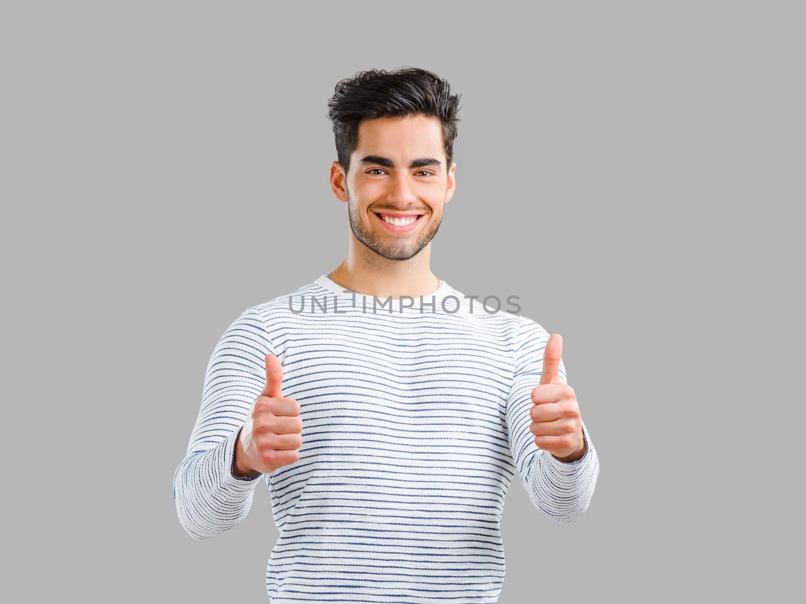 Happy and handsome young man talking at phone, isolated on white background