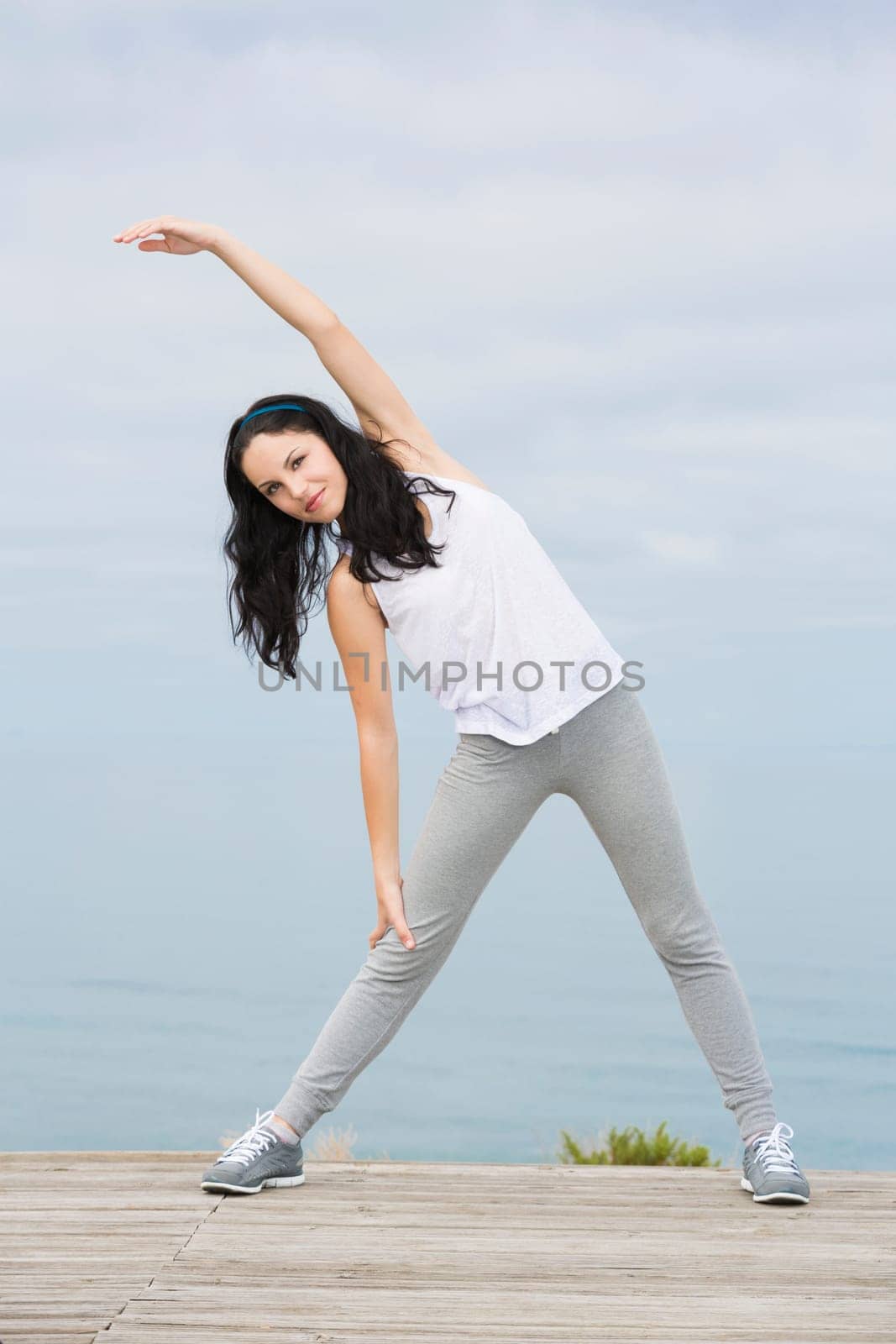 Beautiful young woman in outdoor doing yoga