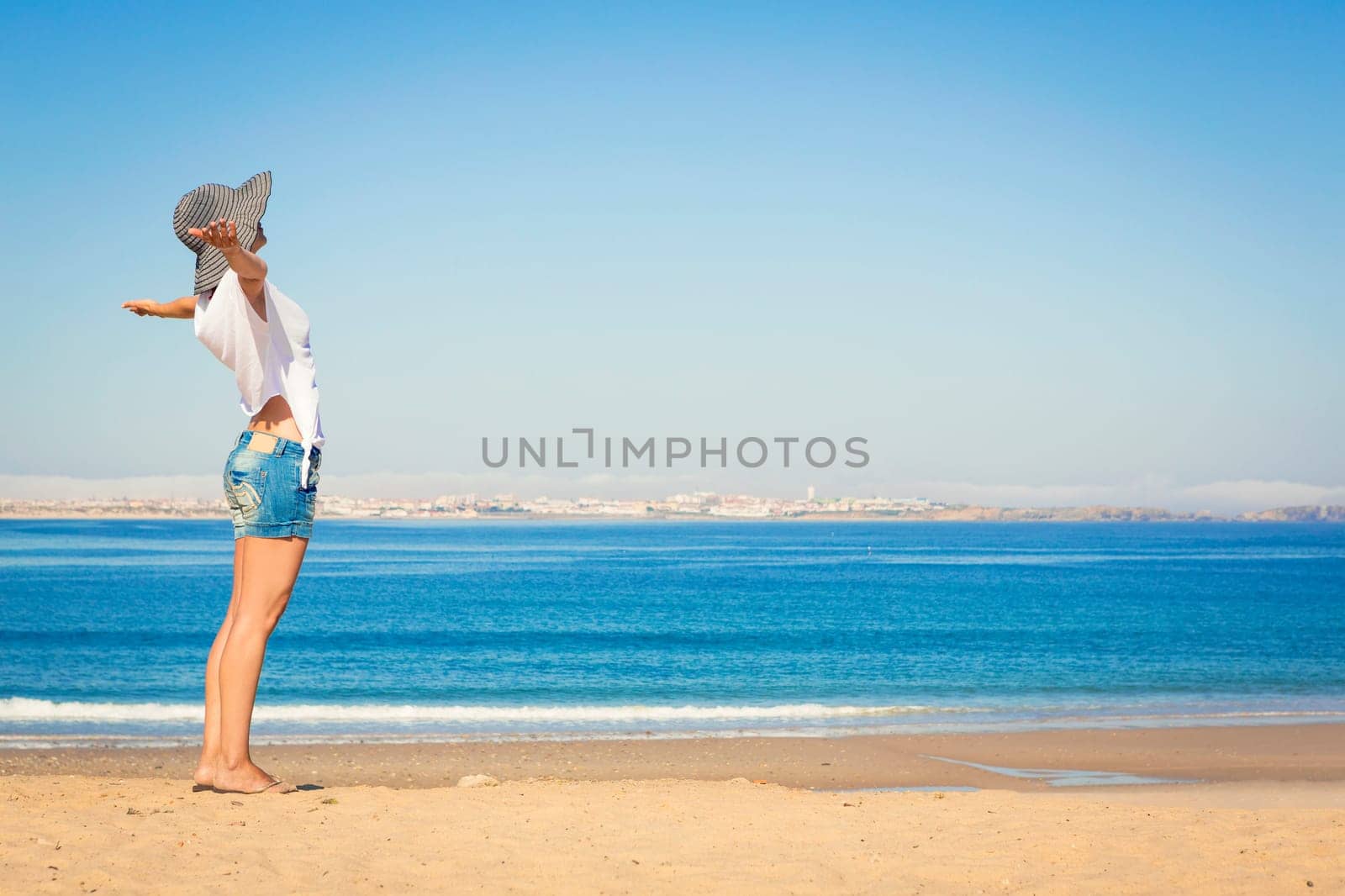 Beautiful young woman enjoying the beach