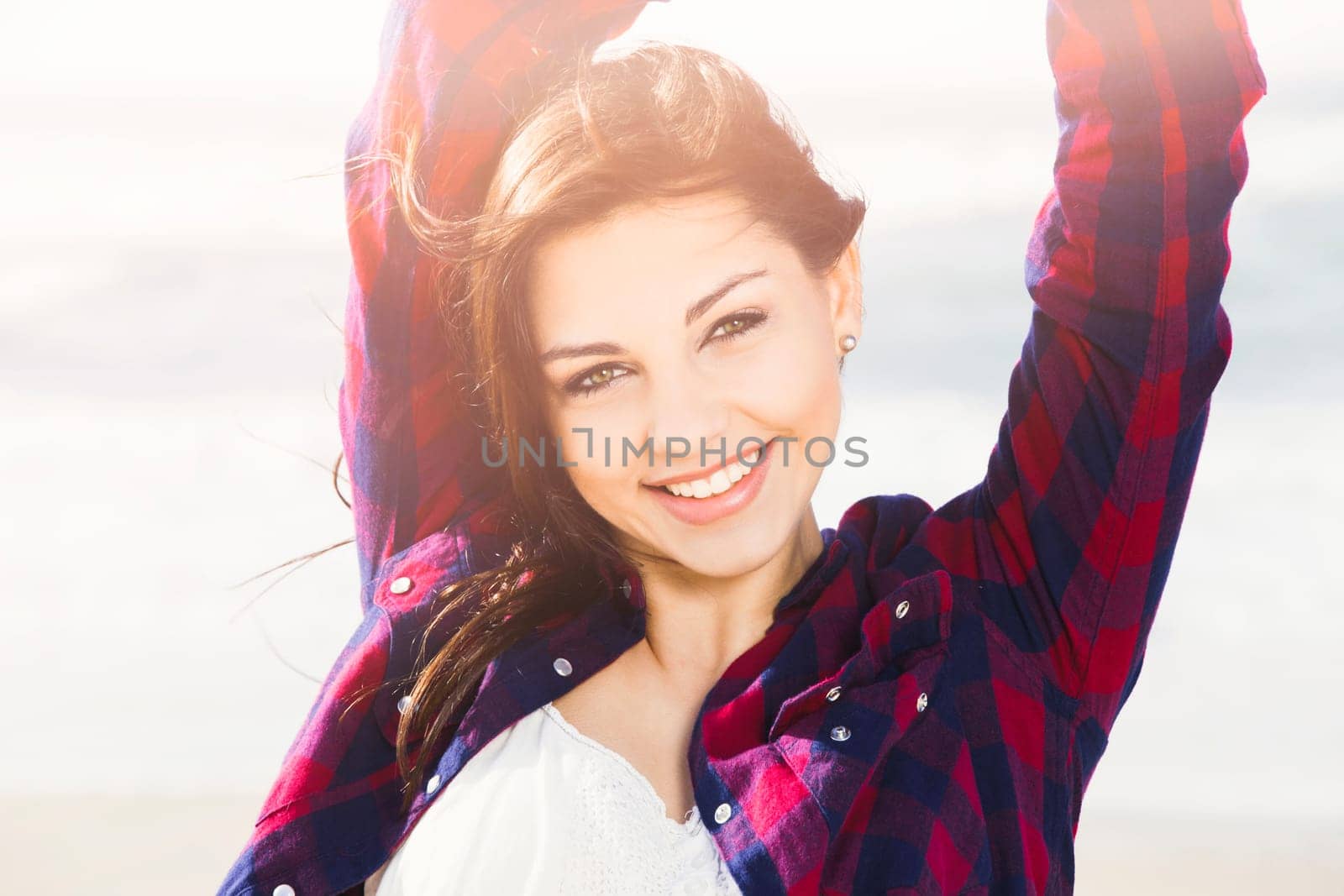 Portrtait of a happy girl at the beach enjoying the life