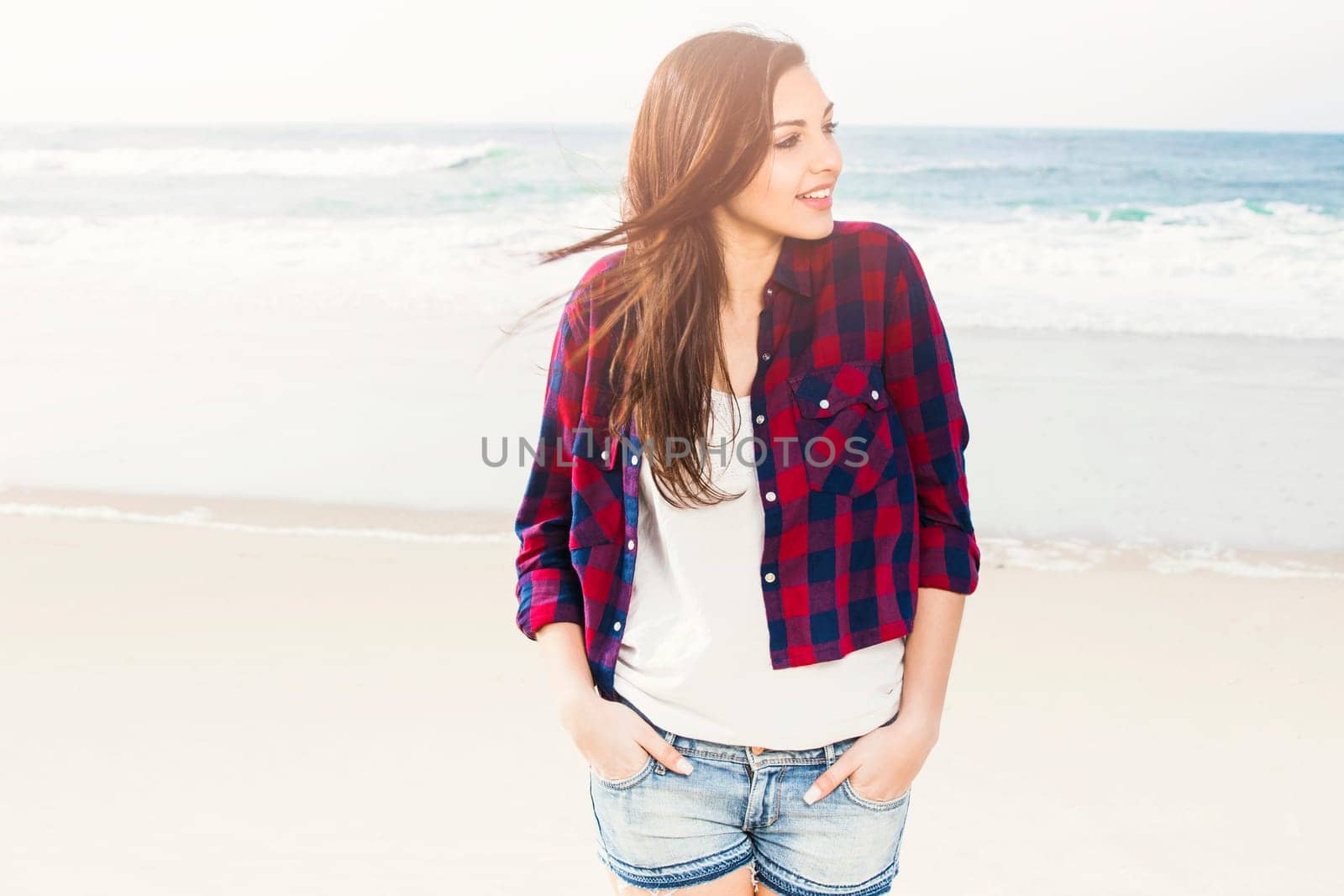 Portrtait of a happy girl at the beach enjoying the life
