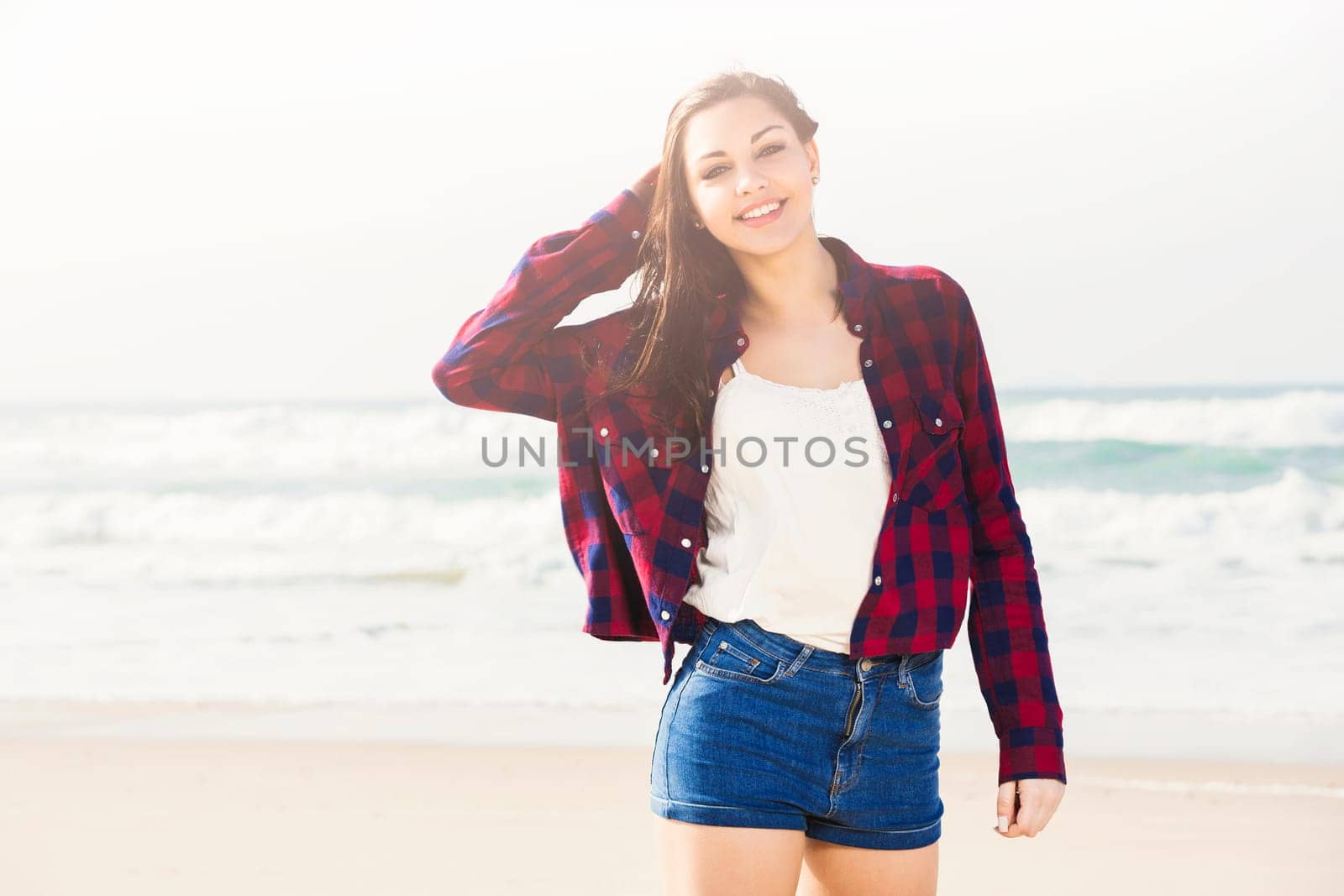 Portrtait of a happy girl at the beach enjoying the life