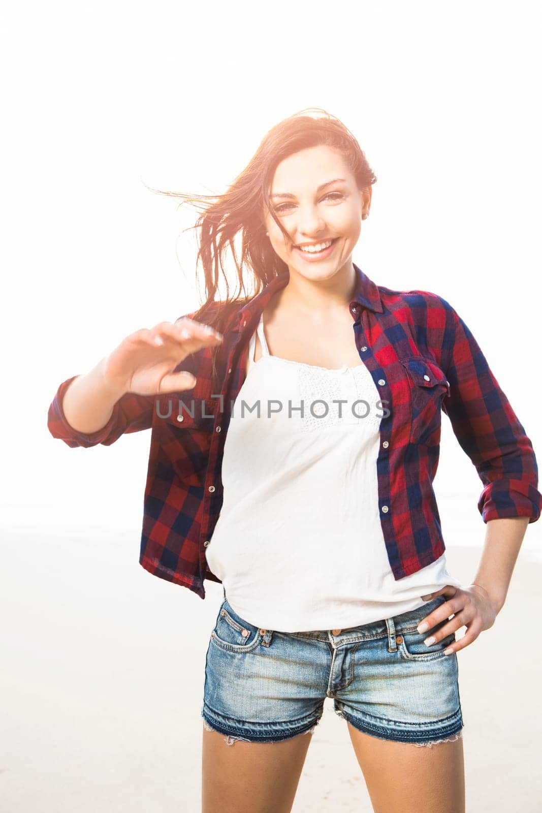 Portrtait of a happy girl at the beach enjoying the life