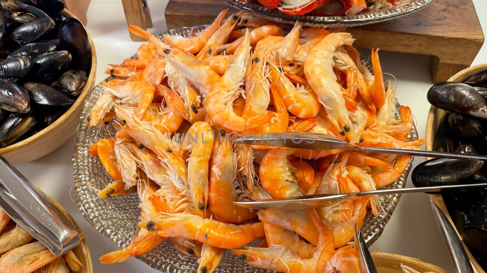 Shrimp and prawns in a bowl on a buffet.