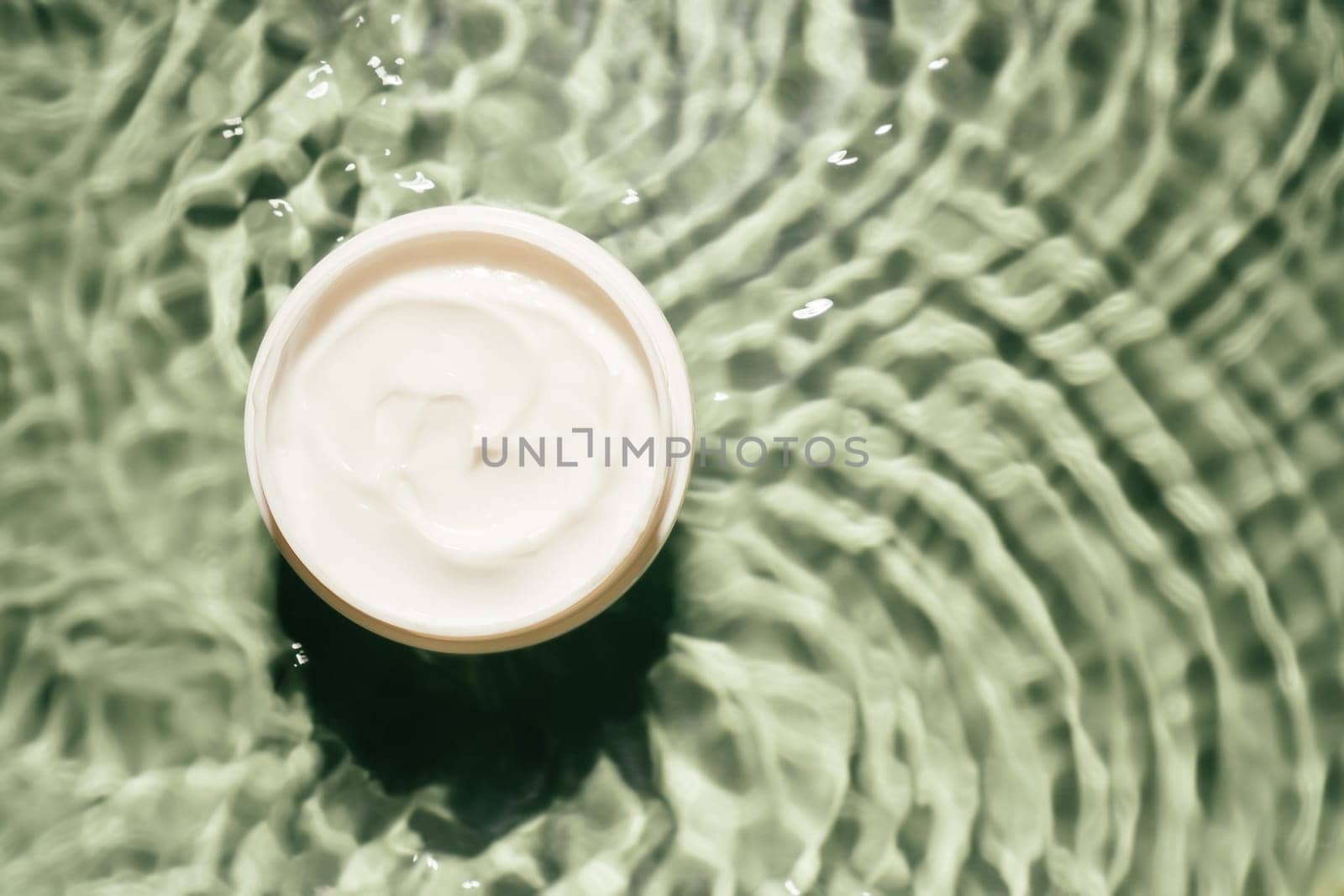 White plastic jar pot of facial and body cream gel collagen for anti aging wrinkles treatment. Water waving rippled. Professional spa relaxation moisturizer, healthy skin care. Flat lay, copy space.