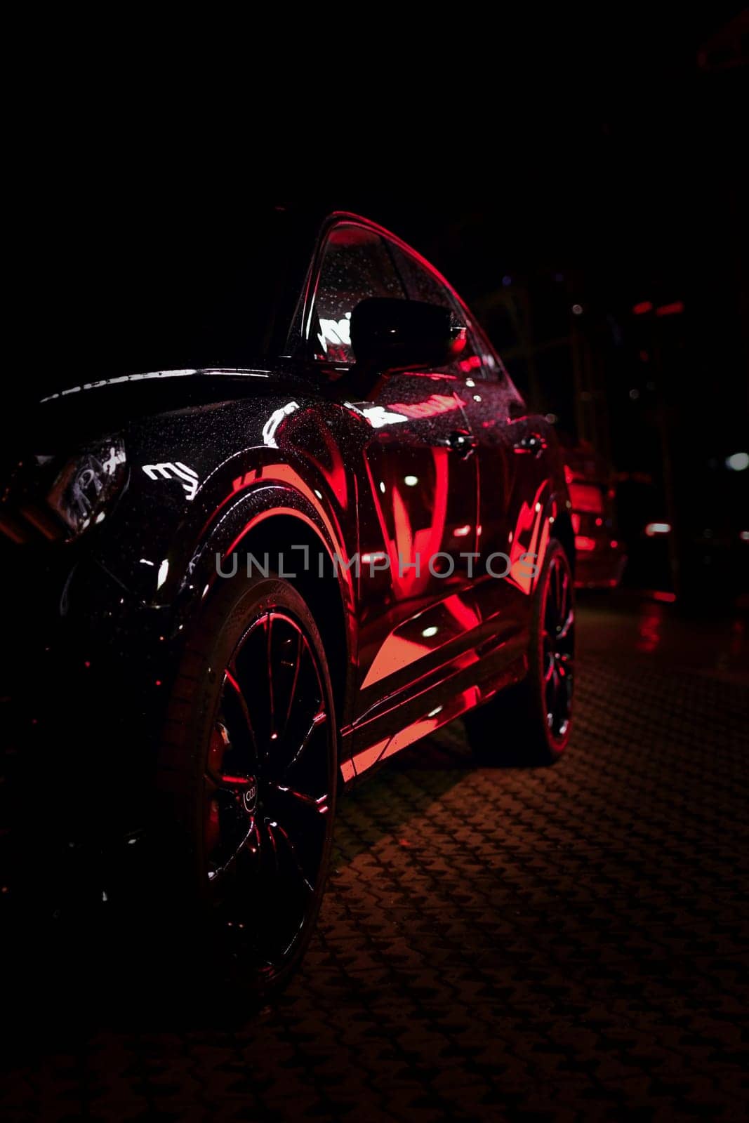 Light reflected in black Audi SUV at night, Boch, Germany