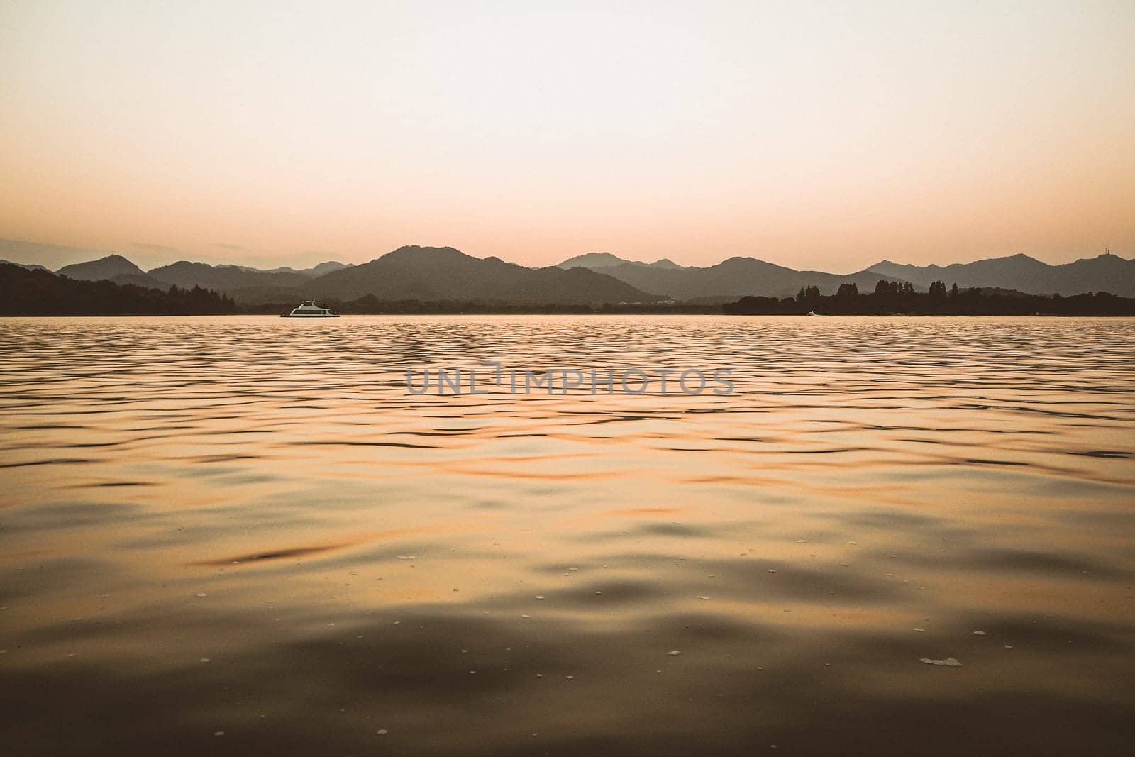 Panorama scenery of Morning fall nature misty foggy scene: forest with trees surrounded by  mist on the water surface of lake with hills and