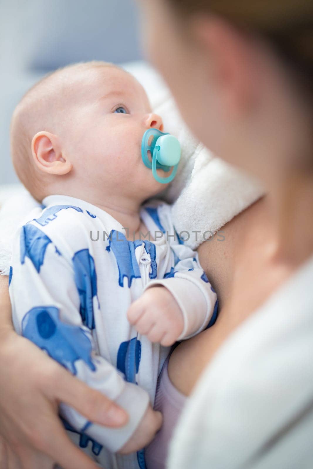 Young mother is holding her little baby