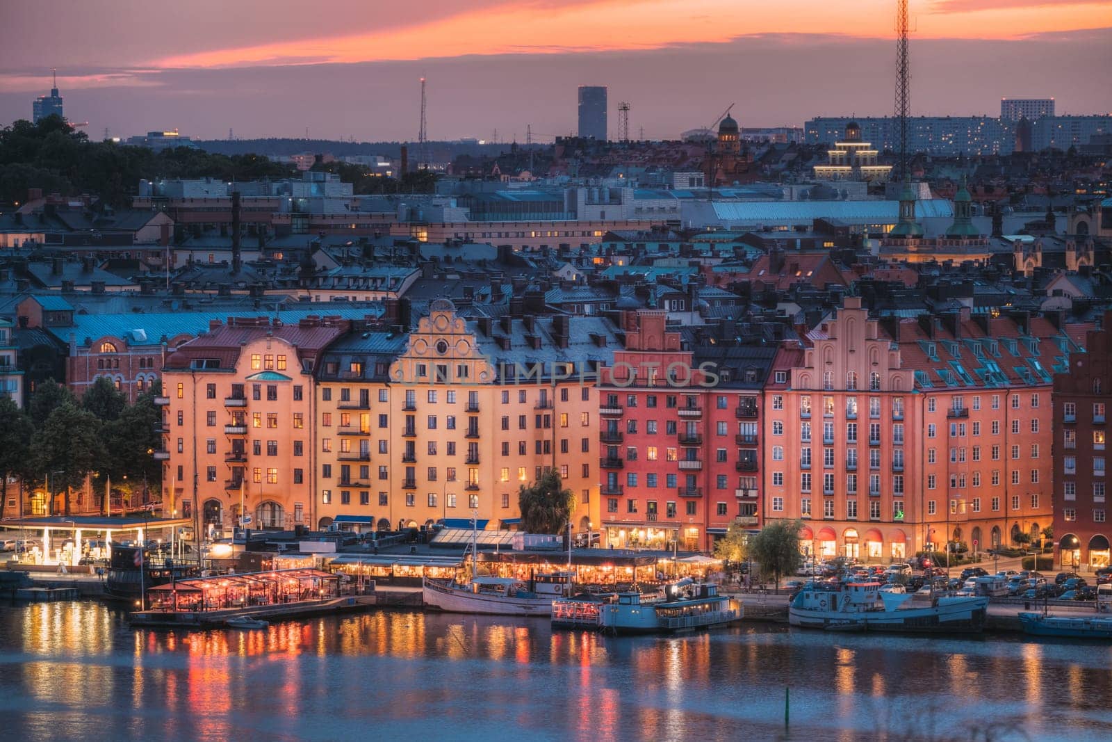 Stockholm, Sweden. Skyline View Of Residential Area Houses In Norr Malarstrand Street, Kungsholmen Island. Scenic View In Sunset Twilight Dusk Lights. Evening Lighting