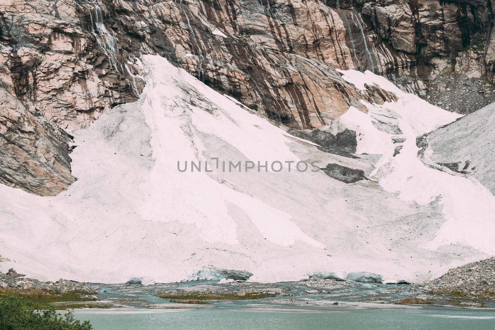 Jostedalsbreen National Park, Norway. Close Up View Of Melting Ice And Snow, Small Waterfalls On Boyabreen Glacier In Summer Sunny Day. Famous Norwegian Landmark And Popular Destination. Close Up.