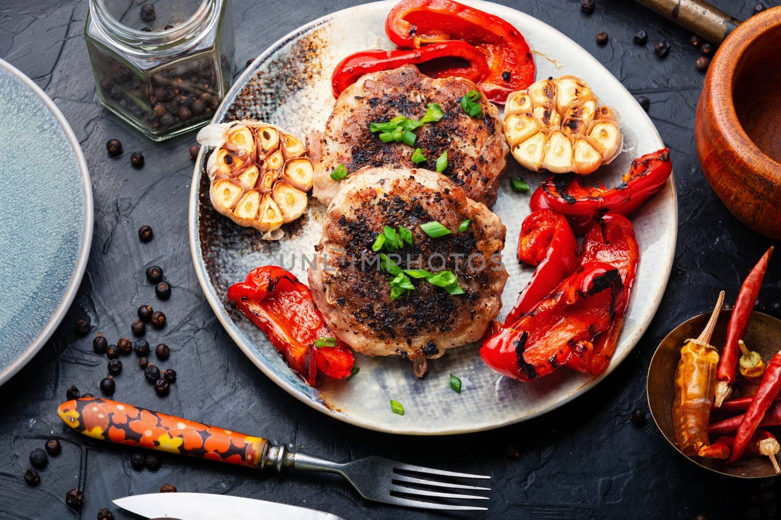 Grilled beef steak, beef and pork with spices. Grilled meat in bacon.