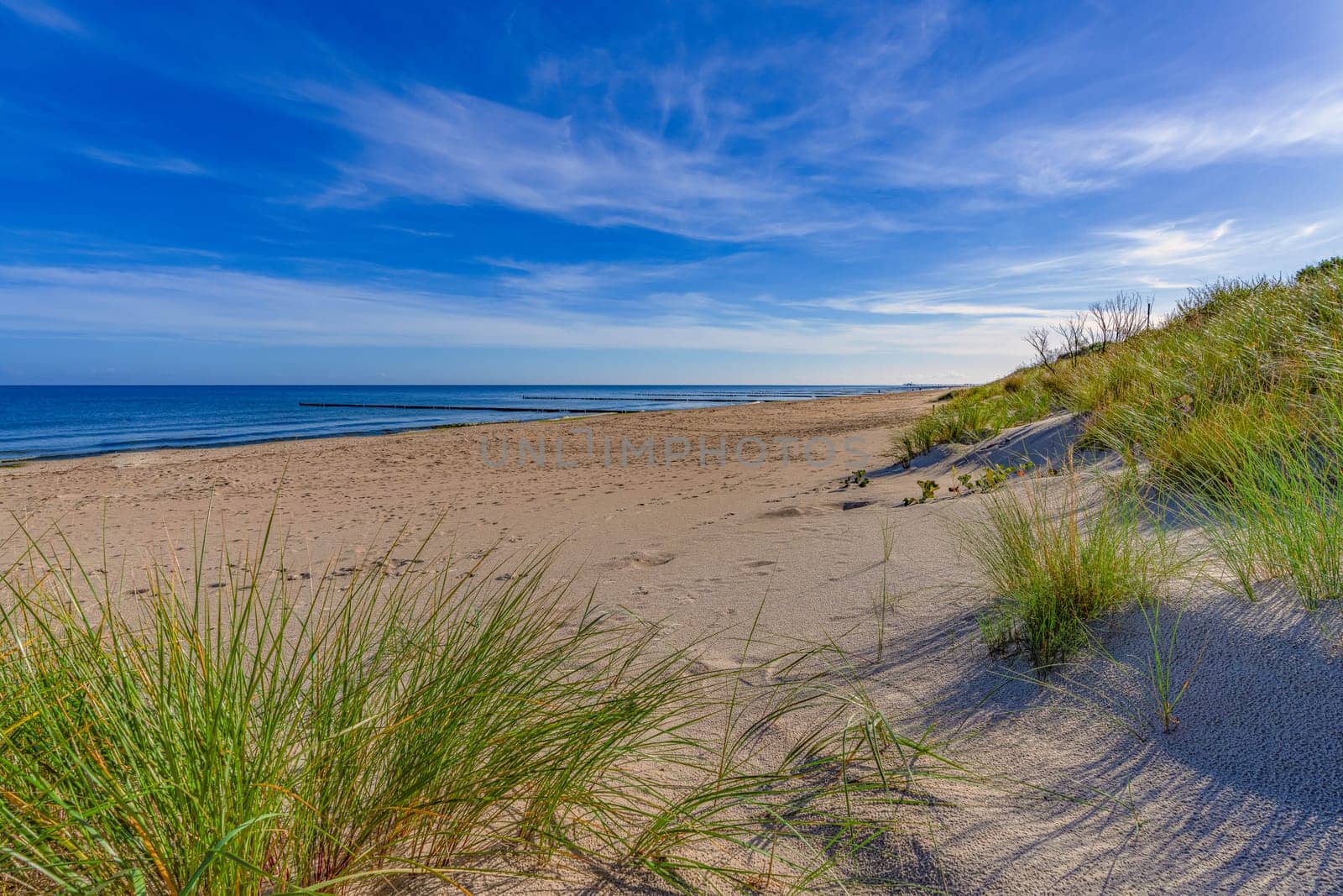 dreamlike, empty baltic sea beach on the island Usedom near Zinnowitz with blue sky