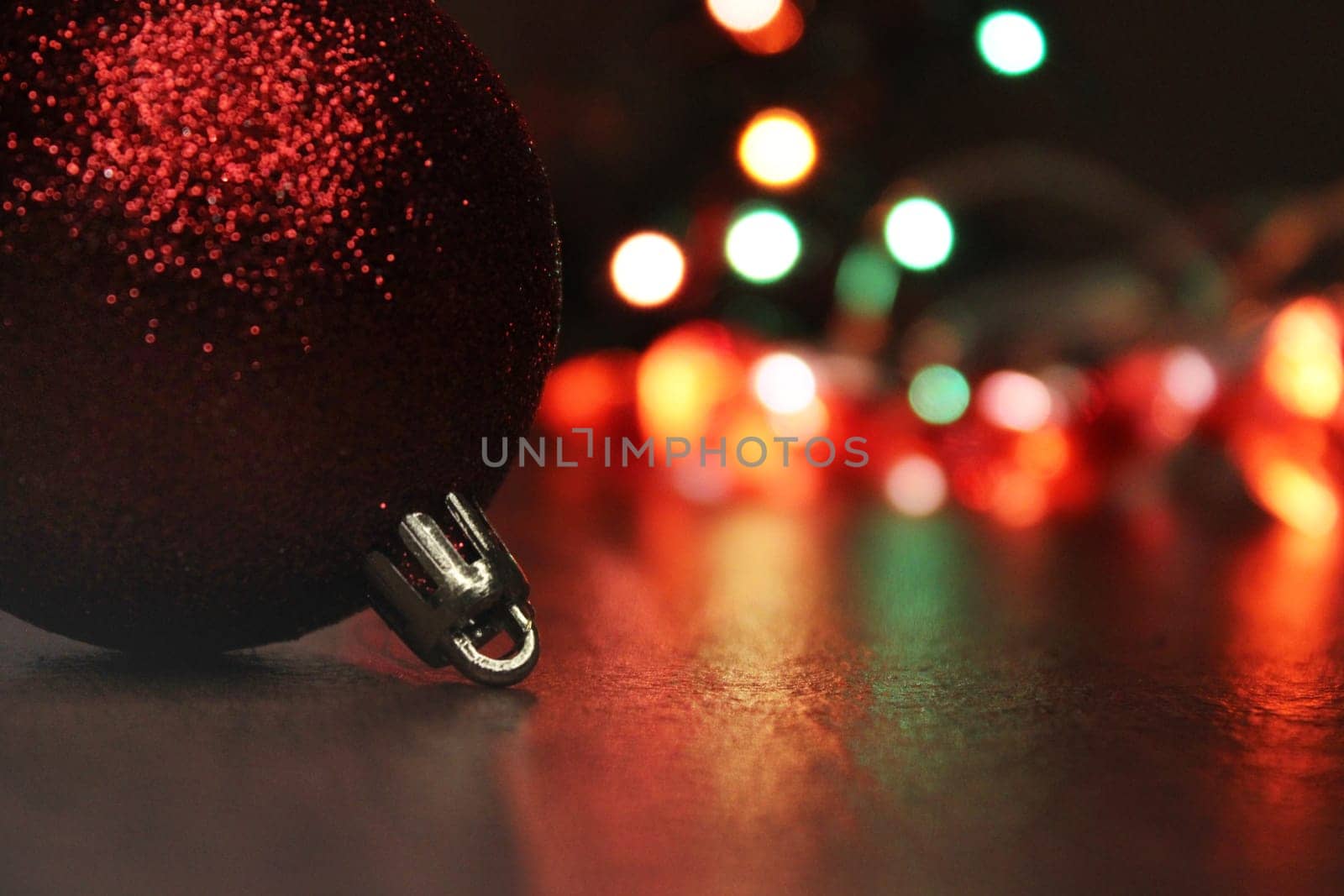 Christmas ball close-up against the background of multi-colored city lights. Concept of christmas, new year. Blurred background.