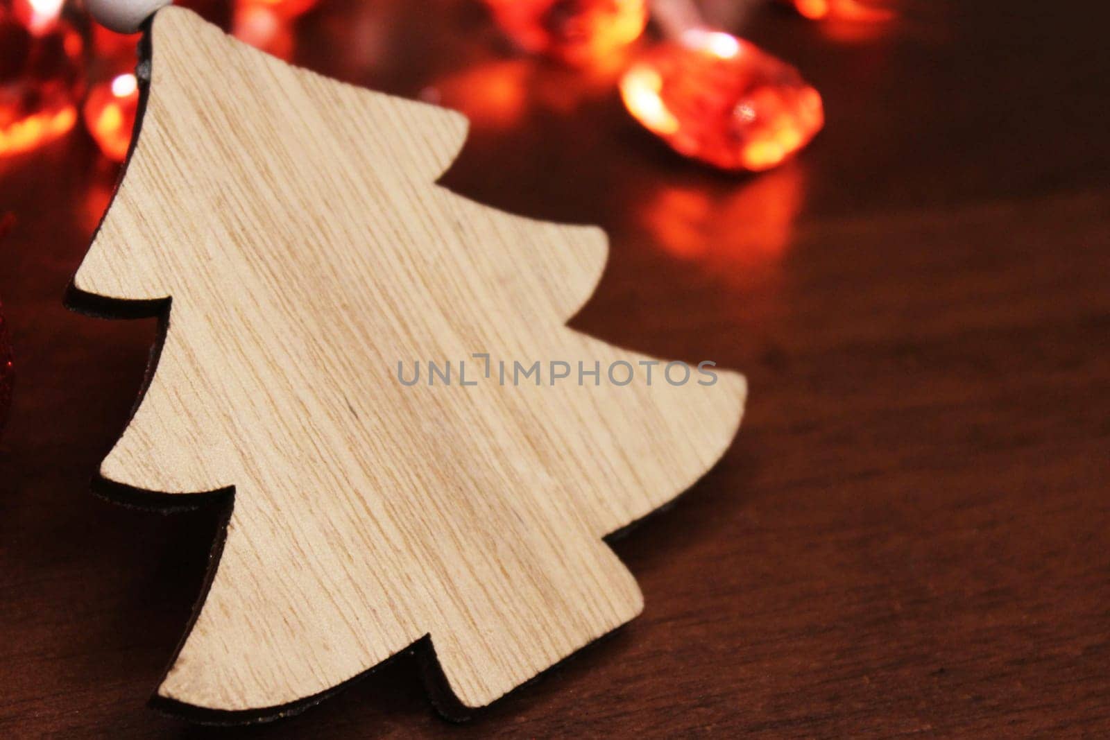 Christmas tree made of handmade wood on the background of a Christmas garland. Concept of christmas, new year, ecology.