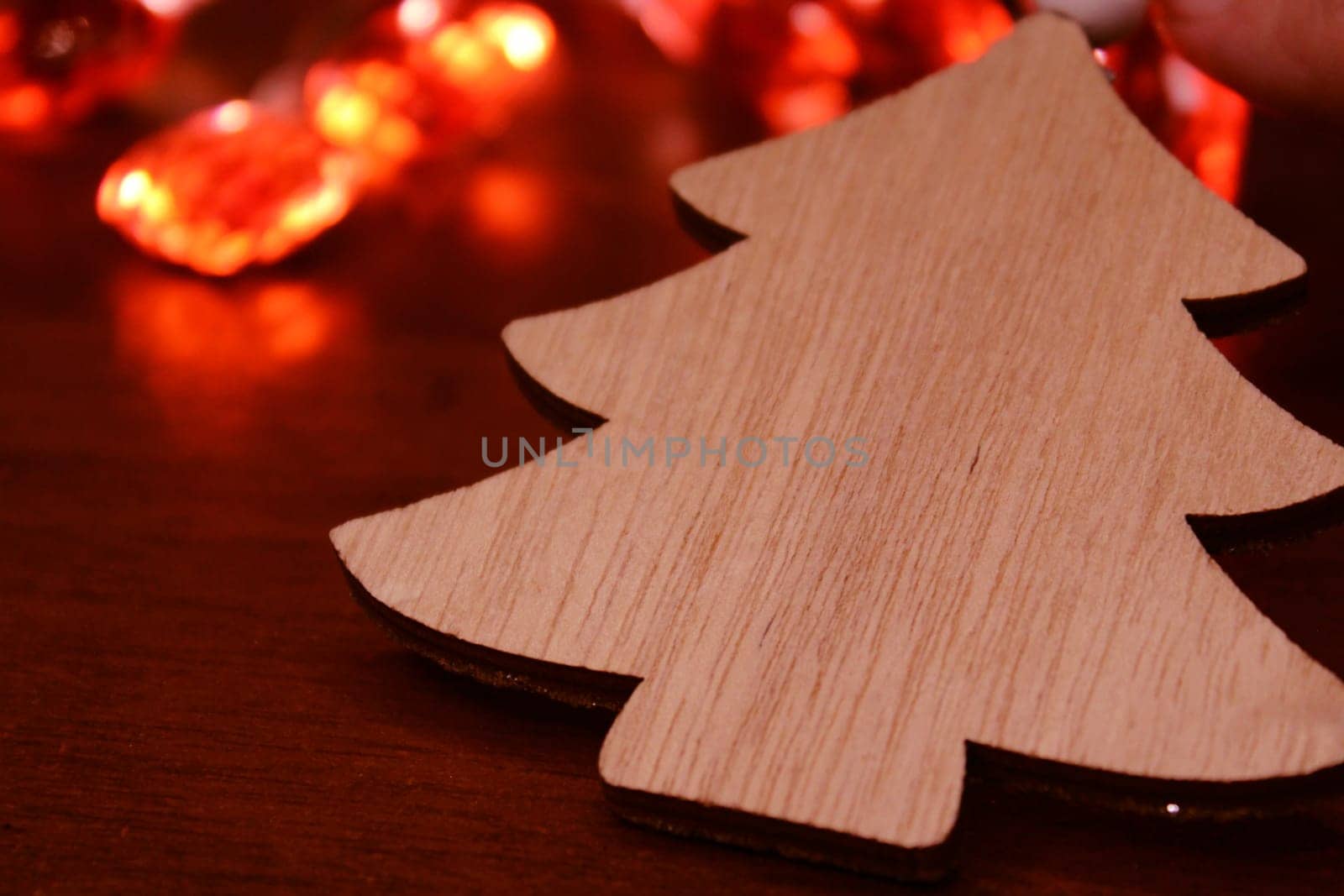 Christmas tree made of handmade wood on the background of a Christmas garland. Concept of christmas, new year, ecology.
