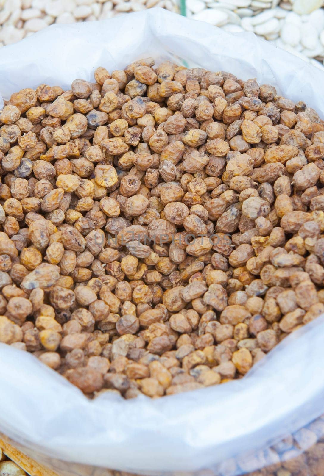 Rolled up sack full of tiger nuts or chufas. Displayed at street market stall