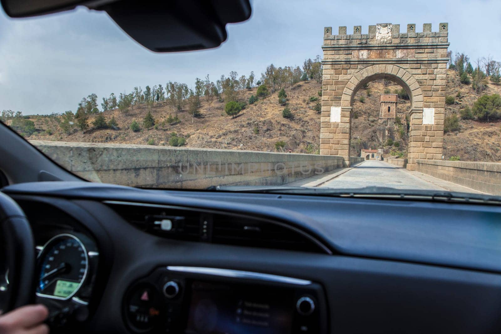 Crossing roman bridge of Alcantara which is still in use from II century B.C. View from the inside of the car