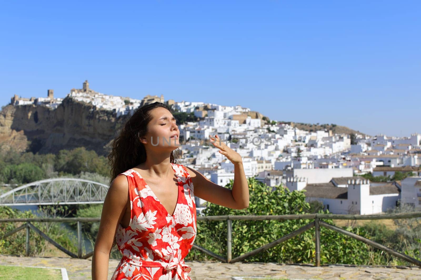 Stresed tourist suffering heat stroke complaining outdoors