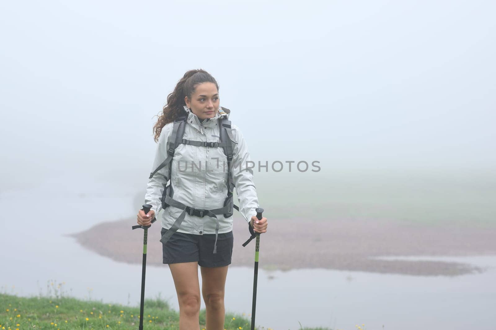 Hiker walking alone in the mountain in the fog