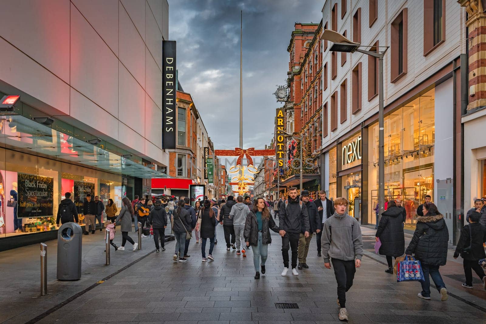 Dublin, November 2019 Henry Street decorated for Christmas with crowds of people enjoying shopping. The Spire on OConnell street visible in background