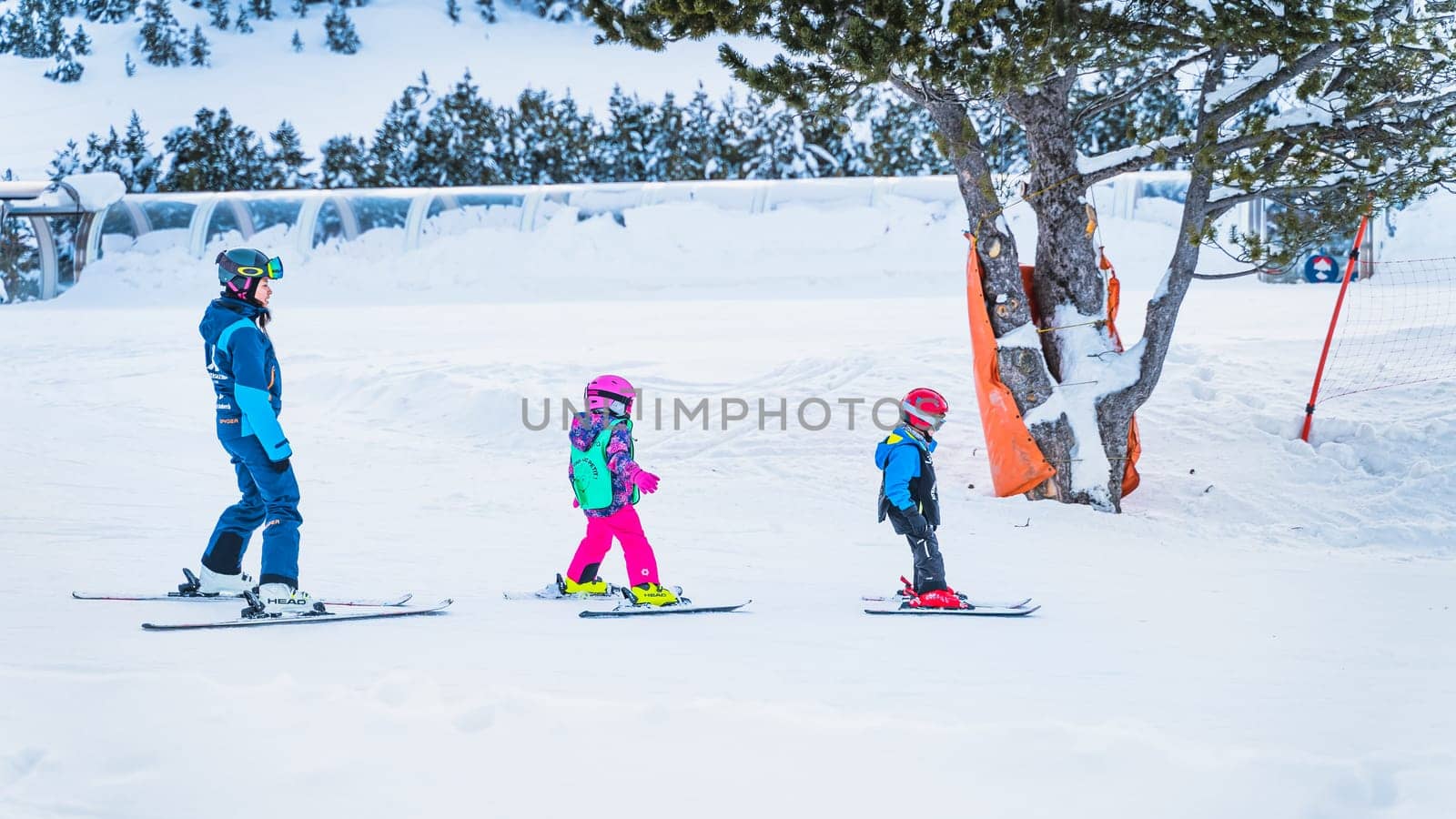 El Tarter, Andorra, Jan 2020 Woman ski trainer teaching young group of kids how to ski. Winter holidays in Pyrenees Mountains, Grandvalira