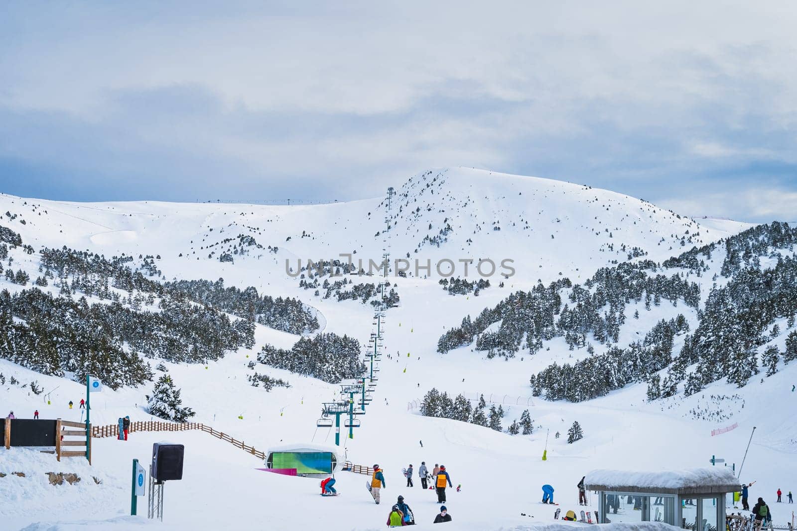 El Tarter, Andorra, January 2020 Group of people, skiers and snowboarders taking on ski lift in Pyrenees Mountains, Grandvalira
