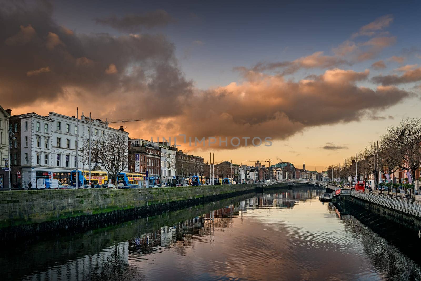 Dublin, November 2019 Early morning, sunrise, on busy Wellington Quay with a view on Hapenny Bridge crossing River Liffey