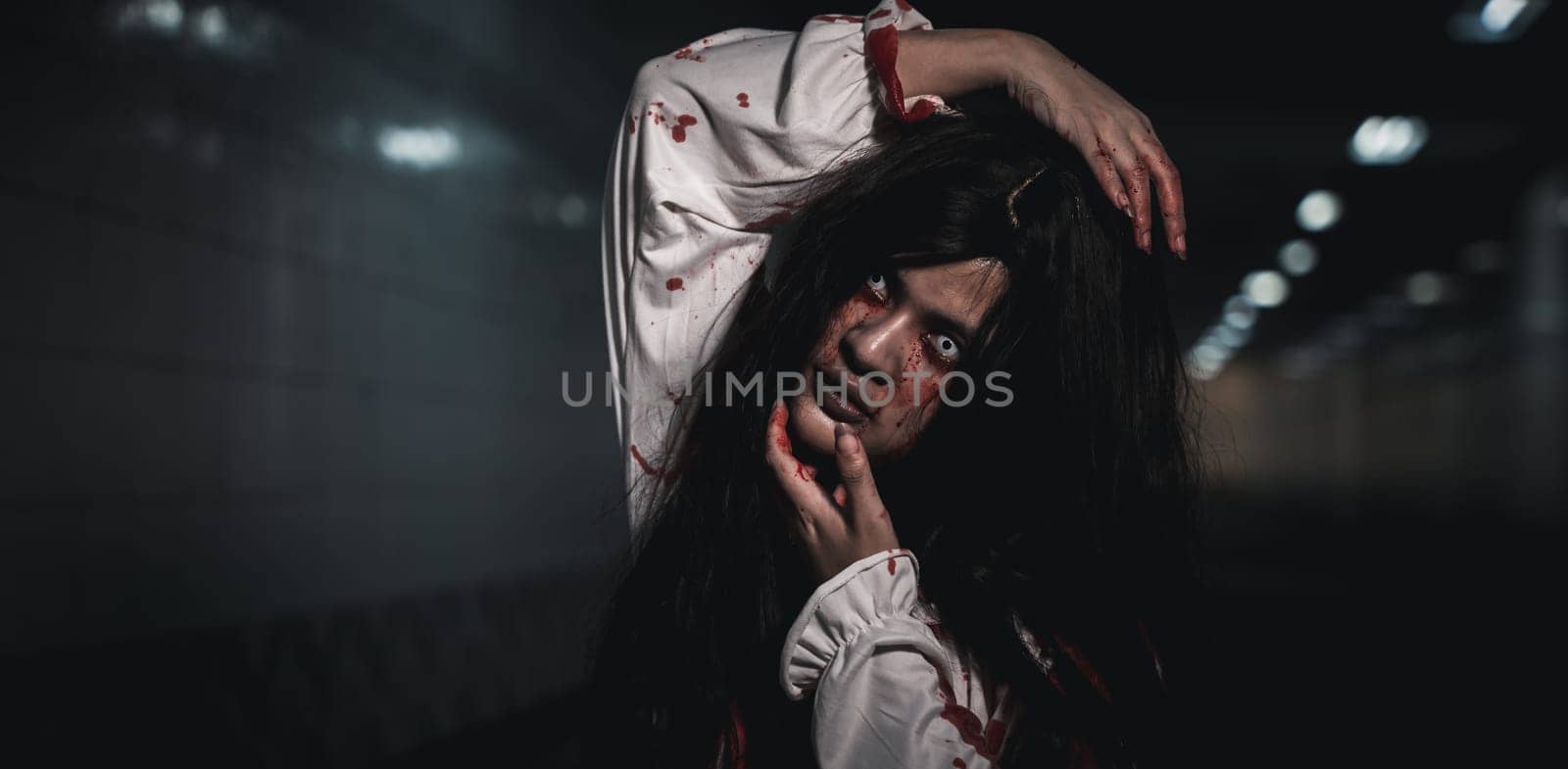 Horror bloodthirsty woman ghost or zombie she is horror scary with breaks her neck at dark night, Screaming zombie female face with blood, Happy halloween day festival concept