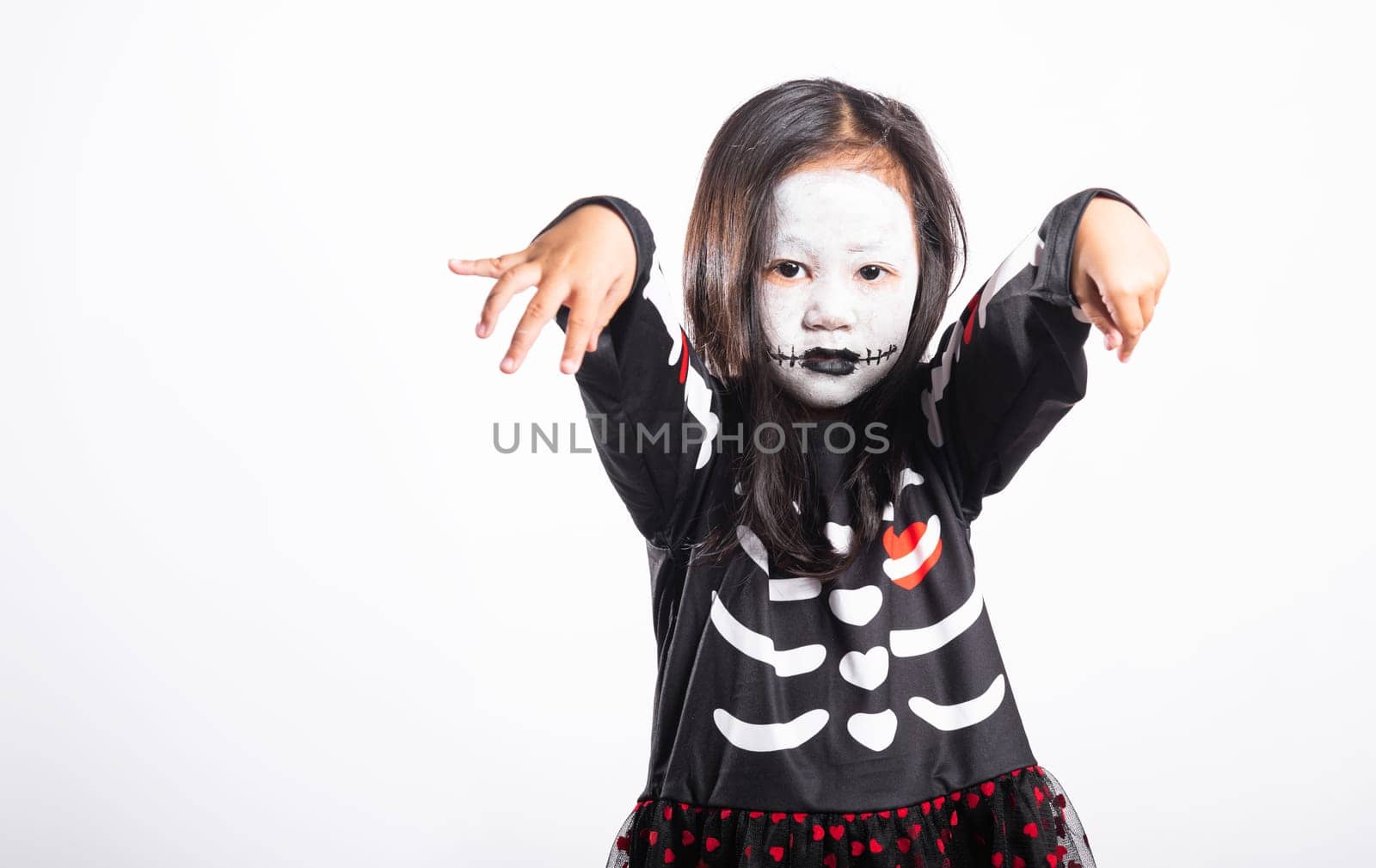Halloween Kid. Portrait of Asian little kid girl wearing witch costume studio shot isolated white background, Child woman horror face painting make up for scary, Happy halloween day concept
