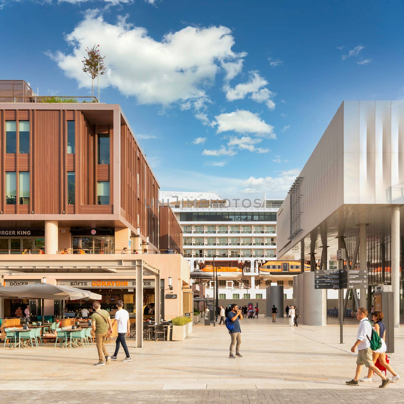 Istanbul, Turkey - August 31, 2022: Internal passage at Galataport, a mixed use development located along shore of Bosphorus strait, in Karakoy district, with docked huge cruise ship in the background