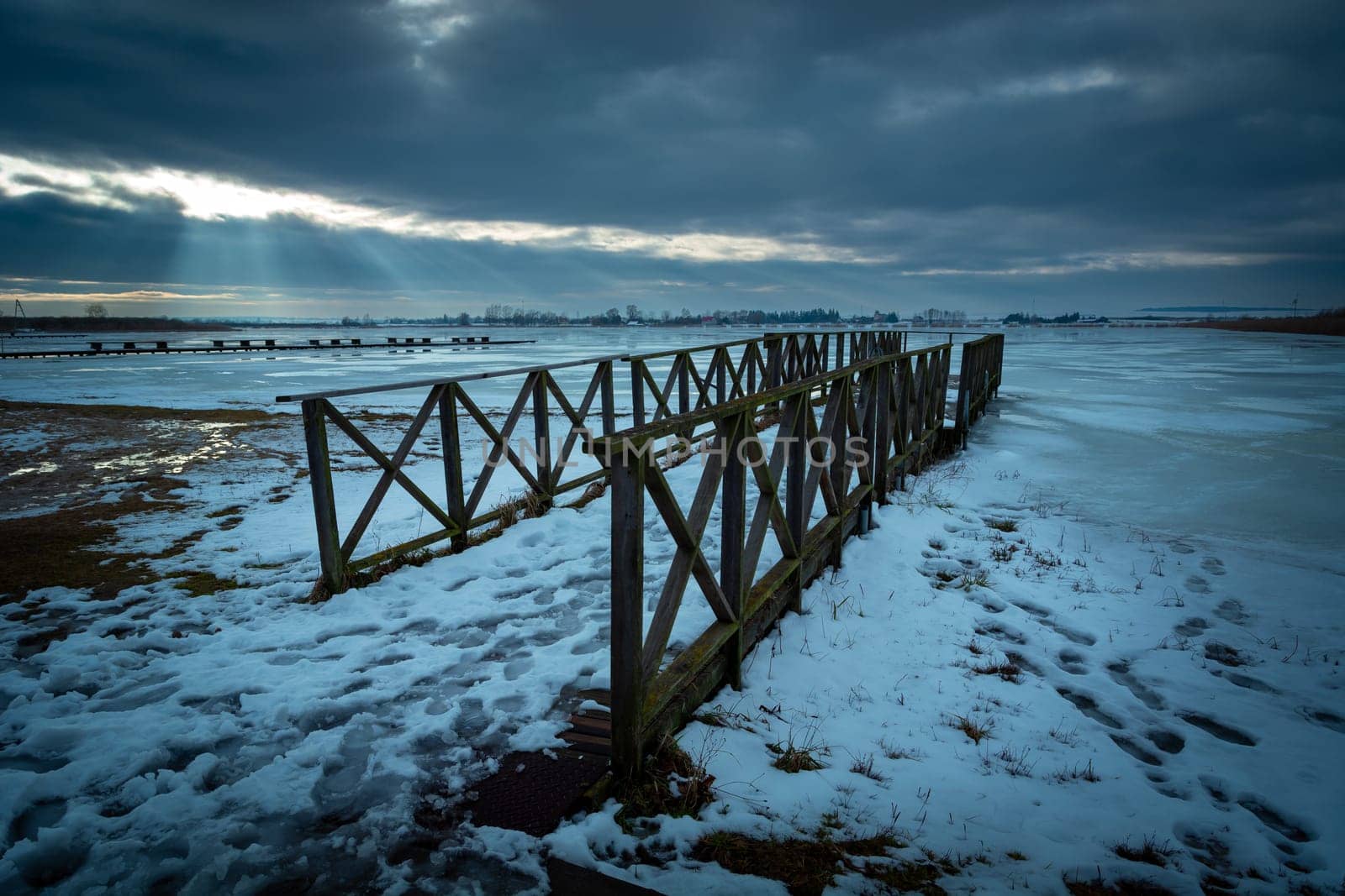 Winter view of the frozen lake with a wooden pier, Zoltance, Poland