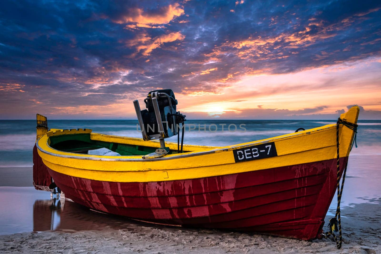 Sunset over Baltic Sea with fishing boat on the beach - Debki, Pomerania, Poland