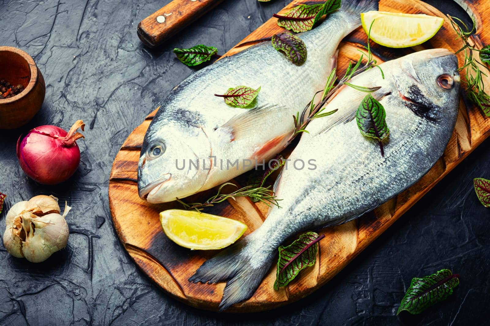 Two raw dorado fish for cooking on a plate. Seafood