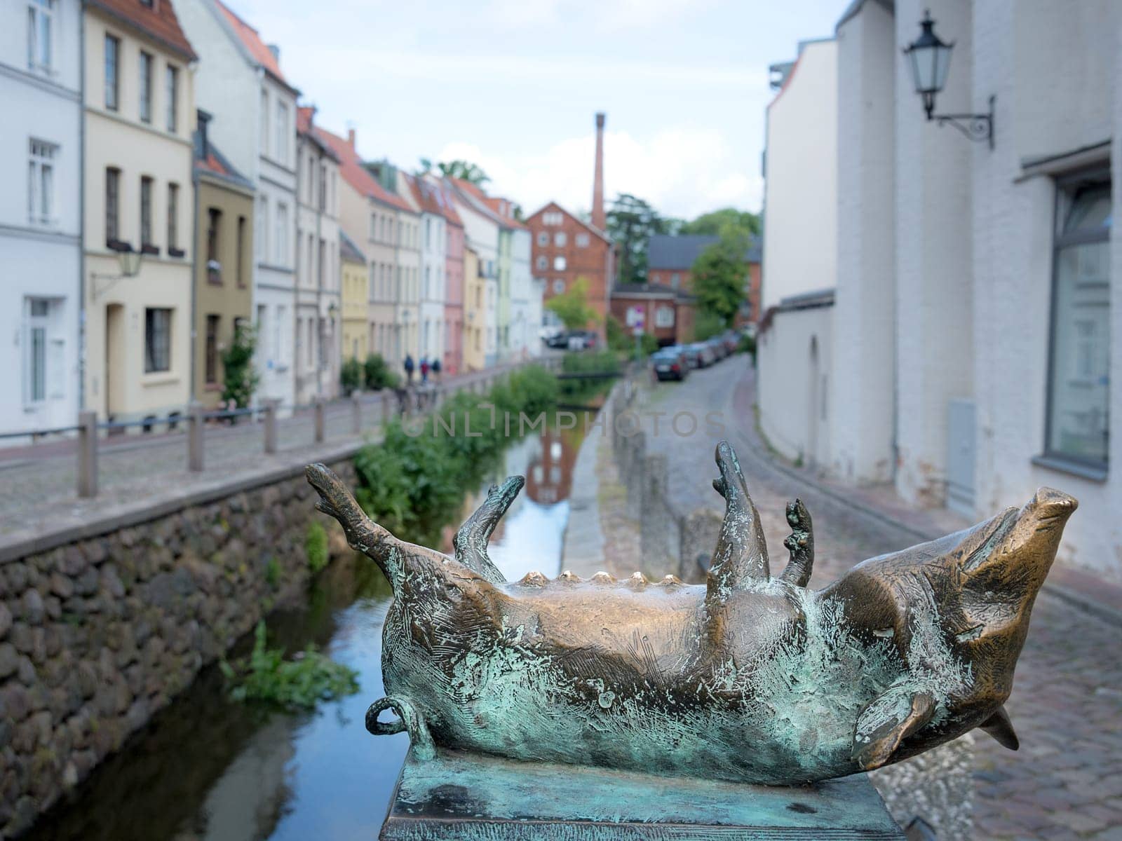 Pig as a bronze statue on the canal bridge in the city of Wismar.