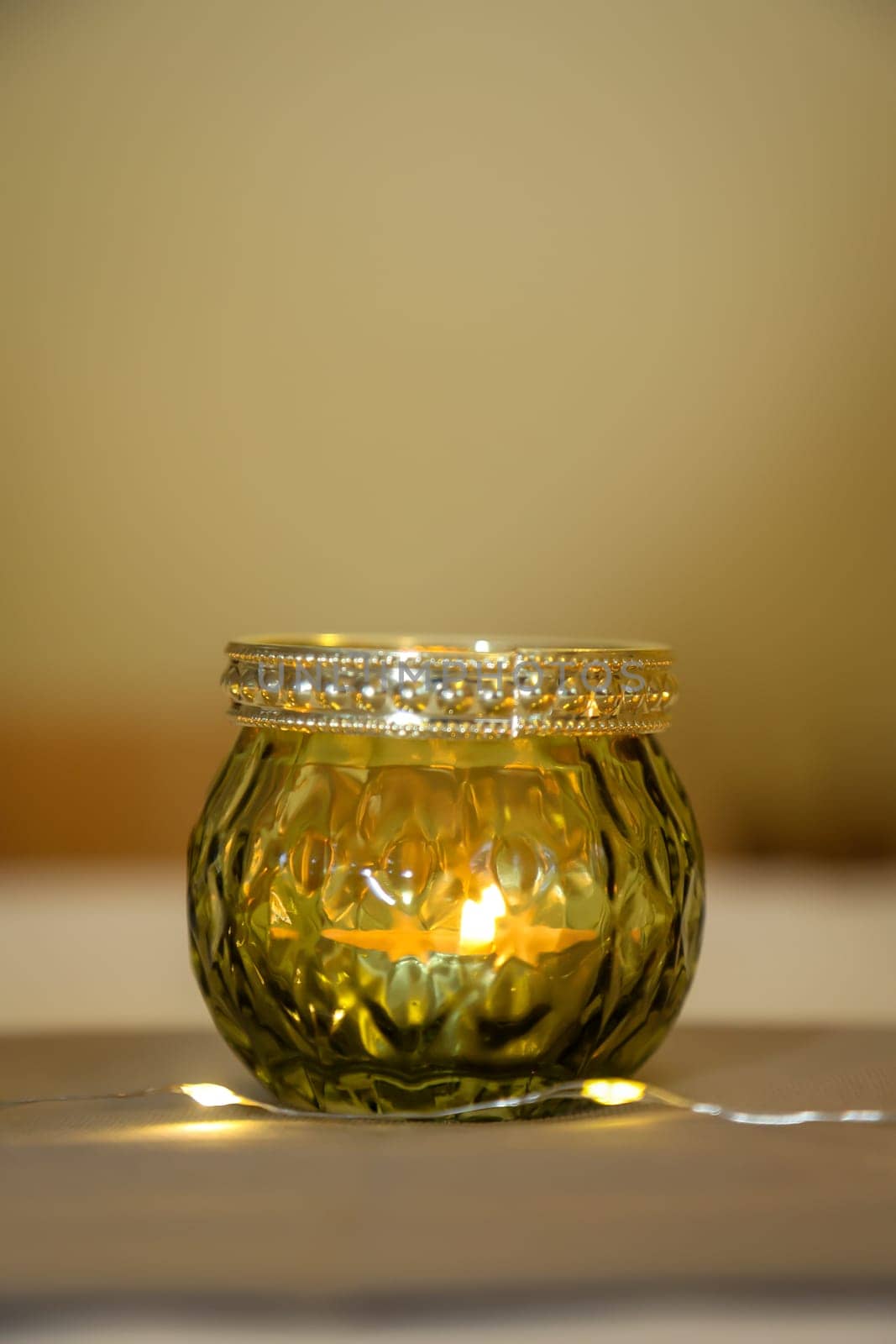 A lantern with a tea light for illumination is on the table.