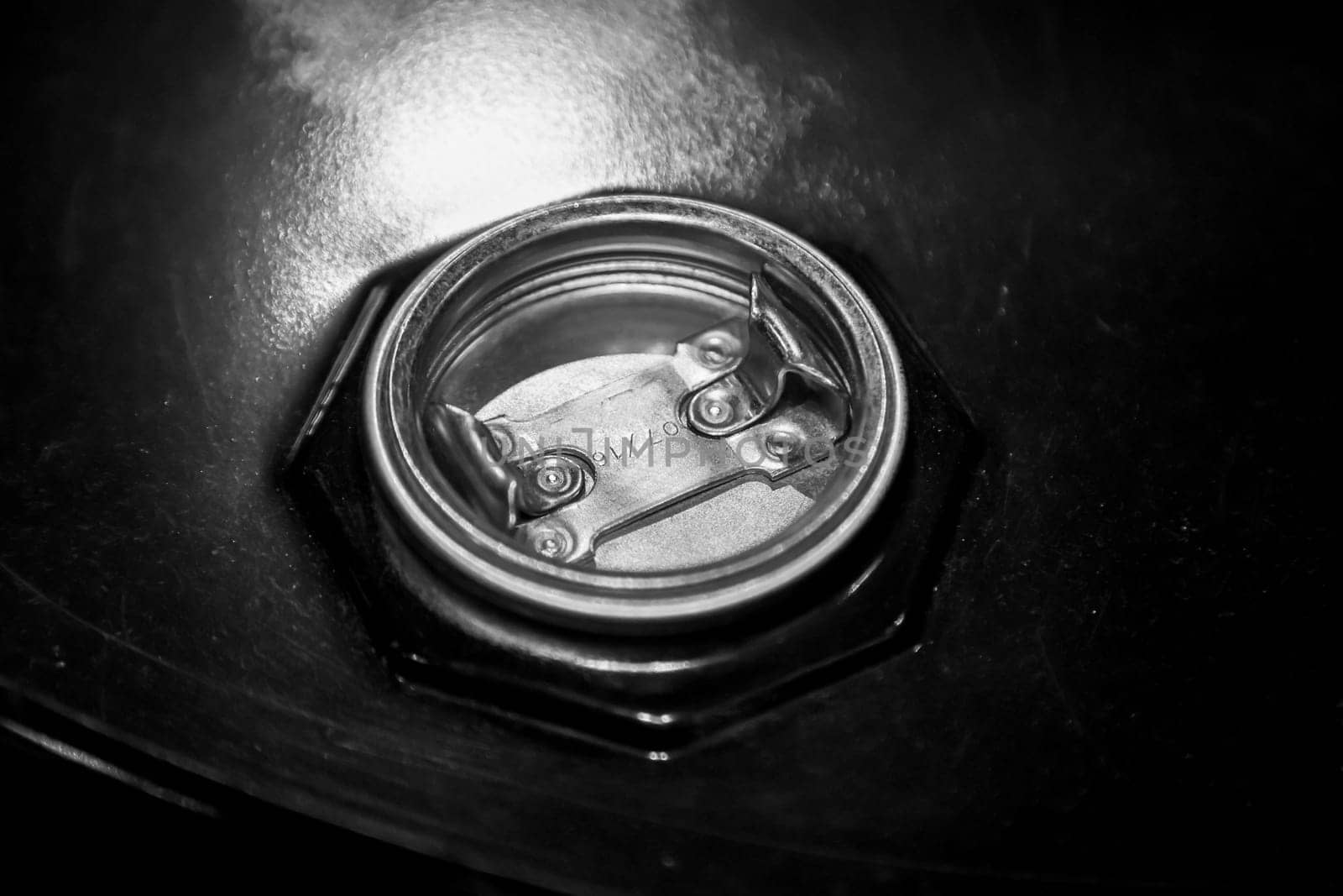 The closure of an old oil drum at a gas station.