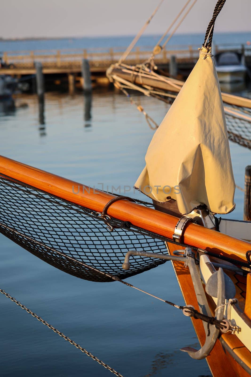 Details of a sailboat which is anchored in the harbor.
