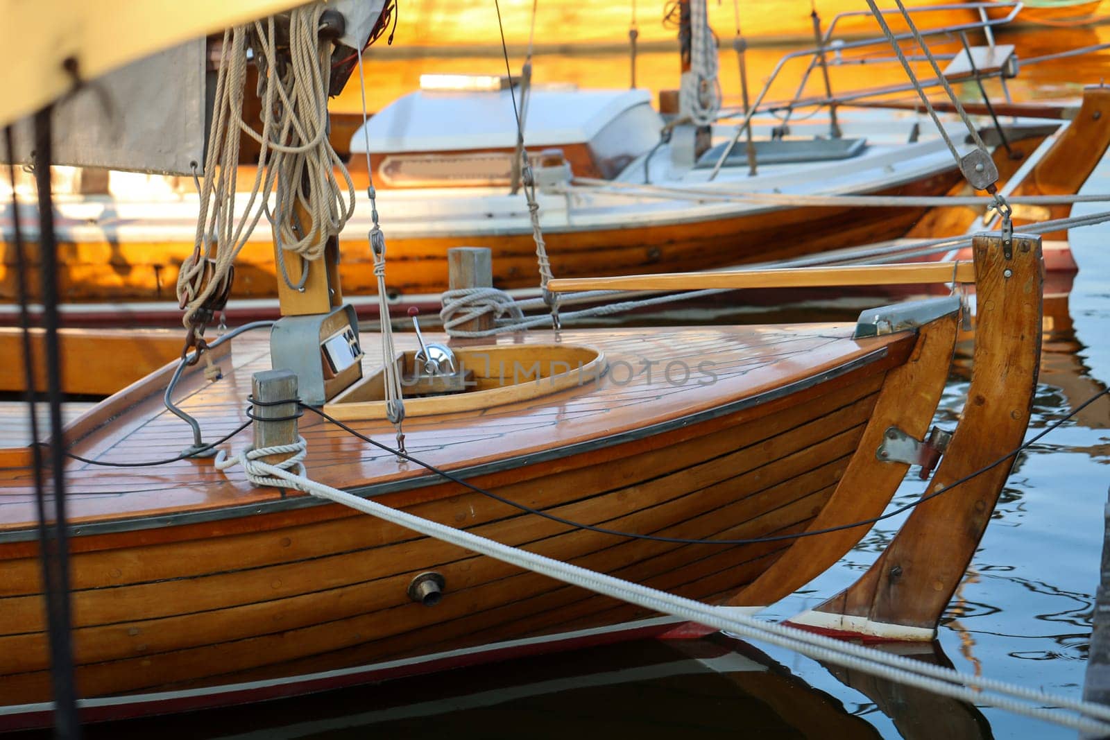 Details of a sailboat which is anchored in the harbor.