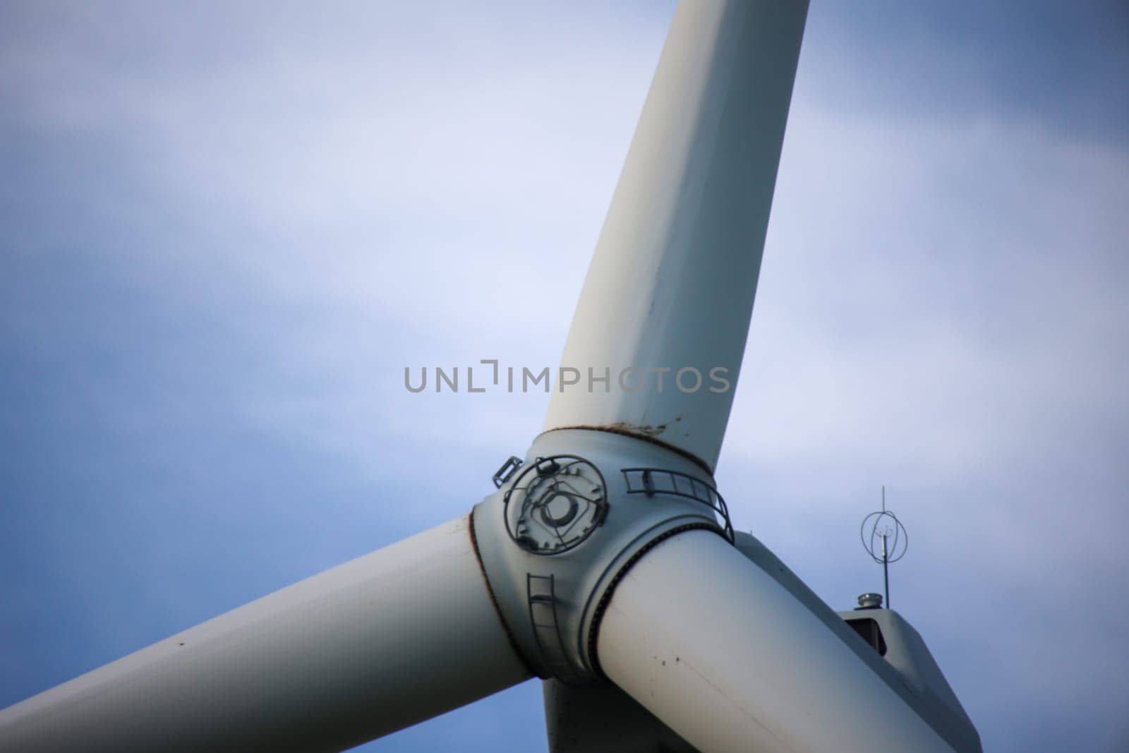 Close-up of the hub of a wind turbine. Blade and hub of a wind turbine.